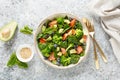 Salmon fish and avocado salad with fresh spinach leaves, broccoli, blueberry dressed with olive oil