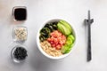 Salmon fish poke bowl with avocado, cucumber, quinoa, wakame seaweed. Buddha bowl Royalty Free Stock Photo