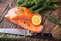 Salmon Fish..Raw salmon fillet pepper salt dill lemon rosemary on wooden table