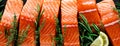 Salmon. Fresh raw salmon fish fillet with cooking ingredients, herbs and lemon on black background, top view, banner Royalty Free Stock Photo