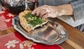 Salmon with garlic and herbs after being baked in the oven, the cook puts it on tray Royalty Free Stock Photo