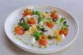 salmon gravlax, salt and sugar cured fresh salmon in a serving plate with leaves and garnish