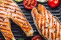 Salmon. Grilled fish salmon. Grilled salmon steak in grill pan on rustic wooden table Royalty Free Stock Photo