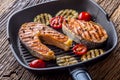 Salmon. Grilled fish salmon. Grilled salmon steak in grill pan on rustic wooden table Royalty Free Stock Photo