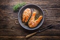 Salmon. Grilled fish salmon. Grilled salmon steak in roasted pan on rustic wooden table Royalty Free Stock Photo