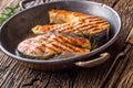 Salmon.Salmon. Grilled fish salmon. Grilled salmon steak in roasted pan on rustic wooden table Royalty Free Stock Photo