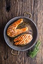 Salmon. Grilled fish salmon. Grilled salmon steak in roasted pan on rustic wooden table Royalty Free Stock Photo