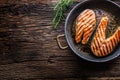 Salmon. Grilled fish salmon. Grilled salmon steak in roasted pan on rustic wooden table Royalty Free Stock Photo