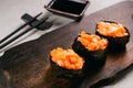 Salmon gunkan maki sushi rolls with soy sauce