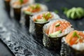 Salmon Hosomaki Sushi, Small Maki Sushi Rolls with Raw Trout, Cucumber, Rice, Sesame And Nori Royalty Free Stock Photo