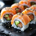 Salmon Hosomaki Sushi, Small Maki Sushi Rolls with Raw Trout, Cucumber, Rice, Sesame And Nori Royalty Free Stock Photo