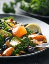 Salmon Kale super food Salad with avocado, pistachio nuts and blueberries on black plate