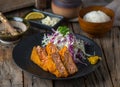 SALMON katsudon katsudon with white rice and salad served in a dish isolated on wooden background side view of japanese food Royalty Free Stock Photo