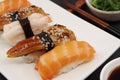 Salmon nigiri, shrimp nigiri, unagi nigiri. Japanese sushi food on a white plate Royalty Free Stock Photo