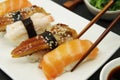 Salmon nigiri, shrimp nigiri, unagi nigiri. Japanese sushi food on a white plate Royalty Free Stock Photo