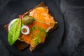 Salmon open sandwich on Pumpernickel bread with vegetables, herbs and soft cheese Royalty Free Stock Photo