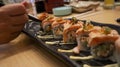 Salmon Oyako Spicy roll consist of crispy salmon skin is wrapped with sushi rice, topped with half broiled Aburi Salmon with spicy Royalty Free Stock Photo