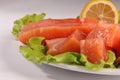 Salmon on a plate with salad and lemon Royalty Free Stock Photo