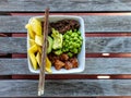 Salmon poke bowl with rice red quinoa edamame mango chopsticks Royalty Free Stock Photo