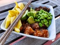 Salmon poke bowl with rice red quinoa edamame mango chopsticks Royalty Free Stock Photo