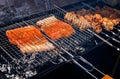 Salmon and pork kebabs grilling outside Royalty Free Stock Photo