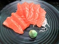 Salmon raw sashimi and wasabi on black plate,Japanese food Royalty Free Stock Photo