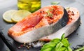 Salmon. Raw Trout Red Fish Steak served with Herbs and Lemon and olive oil on slate. Cooking Salmon, sea food Royalty Free Stock Photo