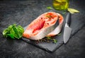 Salmon. Raw Trout Red Fish Steak served with Herbs, Lemon and olive oil on slate. Cooking Salmon, sea food. Healthy eating Royalty Free Stock Photo