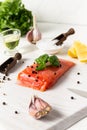 Salmon. Raw trout and red fish steak is served with herbs, lemon and olive oil on a white stone board. Royalty Free Stock Photo