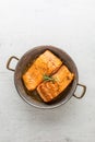 Salmon roast steak. Salmon steak in roast pan on white concrete Royalty Free Stock Photo