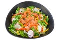 Salmon salad with radish, arugula, and tomatoes isolated on white background