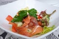 Salmon salad with tomatoes and cucumbers with soy sauce.