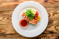 salmon with salad and vegetables - dish on a wooden background Royalty Free Stock Photo