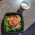 Salmon sandwich, coffee in disposable bowl breakfast travel