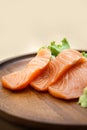 Salmon sashimi in chopsticks, Raw fresh salmon sliced with wasabi and sauce. Japanese food style Royalty Free Stock Photo