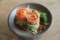 Salmon sashimi with cucumber on wood