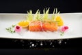 salmon sashimi over ice with lemon slices