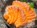Salmon Sashimi, raw salmom sliced serving with ice on black bowl, eating with soy sauce and wasabi. Japanese traditional food Royalty Free Stock Photo