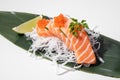 Salmon sashimi on white background. Traditional Japanese food. Raw salmon fish served with red trout caviar. Sushi restaurant menu