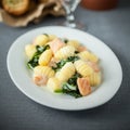 Salmon served with gnocchi and basil