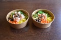 Salmon and prawns poke bowl salad with rice, carrots, edamame, radish and mushrooms