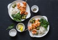 Salmon skewers, olives, spinach, rice - healthy lunch table. Grilled salmon fish skewer and side dish on a dark background Royalty Free Stock Photo