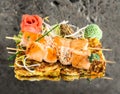 Salmon skewers on vegetable omelette