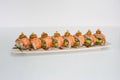 Salmon smoked filled avocado, kani, tamago, cucumber pickle sushi roll with cream cheese