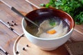 Salmon soup with carrot and parsley