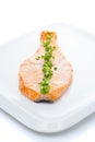 Salmon stake with green onion on white plate isolated Royalty Free Stock Photo