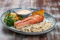 Salmon steak with cheese sauce, blanched vegetables and wild rice Royalty Free Stock Photo