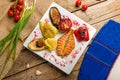 Salmon steak on the grill with grilled vegetables on white plate top view on wooden table Royalty Free Stock Photo