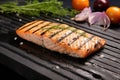 salmon steak with grill marks on a stone slab Royalty Free Stock Photo