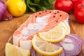 Salmon steak with lemon and onion slices on ice Royalty Free Stock Photo